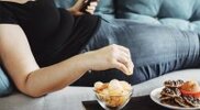Overweight-Female-Eating-Junk-Food-On-The-Couch.jpg